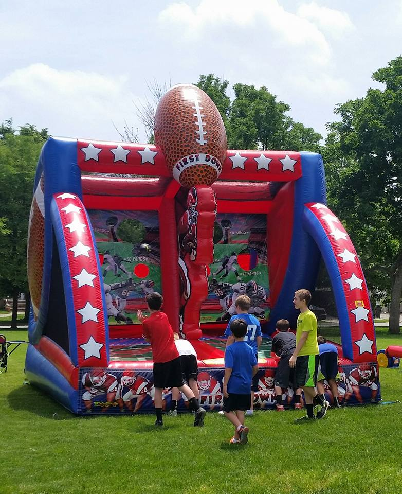 Kids playing inflatable football game at Chicago school event