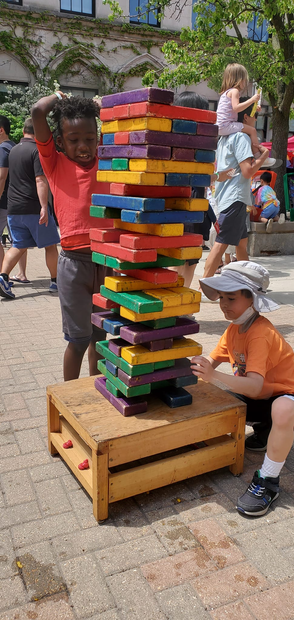 Kids playing giant Jenga carnival game rental at Chicago school fundraiser