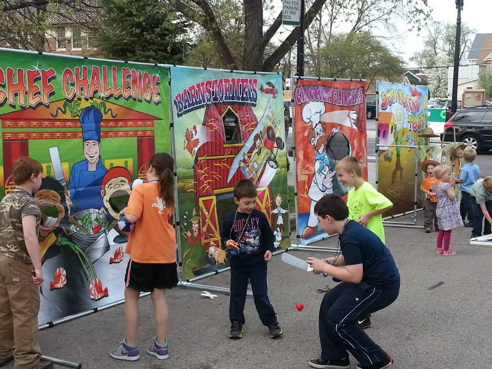 Carnival game booth rentals with colorful backdrops for school festivals in Chicago